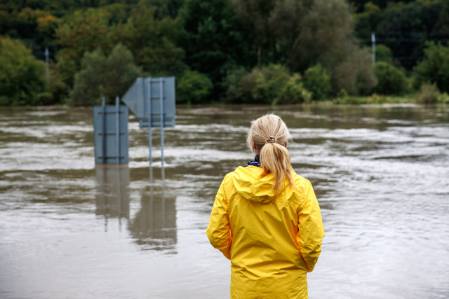 woman looking at flooded streets